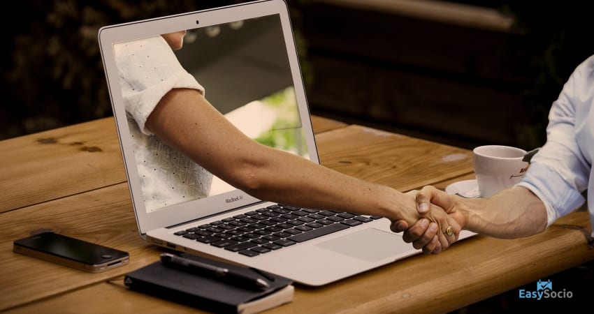 hand reaching out from laptop global reach