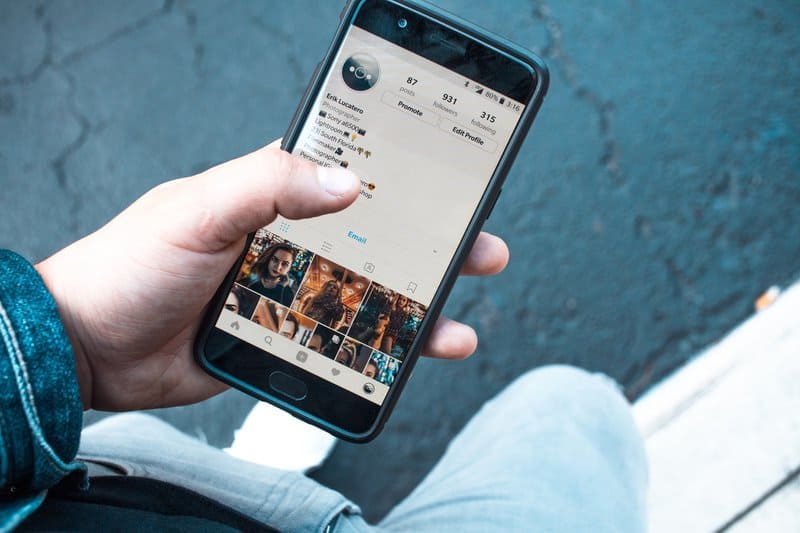 person holding cell phone with Instagram